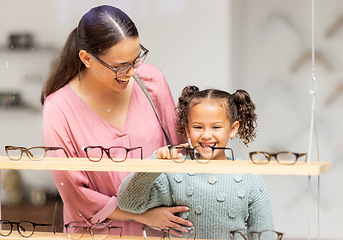 Image showing Decision, glasses and girl with her mother at the optometrist for vision and check on eyes together. Customer, medical and child shopping for eyeglasses with her mom at the ophthalmologist clinic