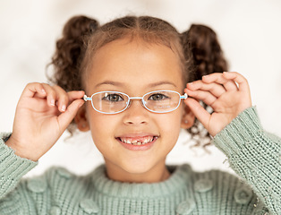 Image showing Child, glasses and eye care for vision, focus and eyesight of girl with a smile and happy about optics decision and lens frame choice. Portrait of kid at optometry store for eye health and care