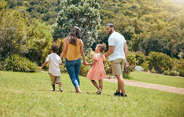Image showing Family, kids and walking in the park for bonding, fun and care in summer outside. Mother, father and parents playfully walk with children, son and daughter siblings in a garden for bond