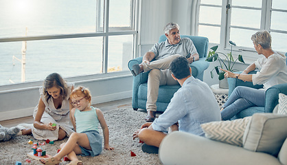 Image showing Family, generations and love together in living room with parents, grandparents and child play with toys and bonding. Big family, men with women and kid at home, spending quality time and care.