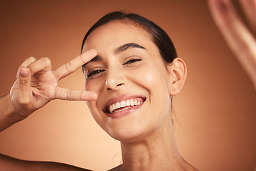 Image showing Face, peace sign and woman happiness selfie of a model with a funny hand sign. Portrait of a comic hand gesture and beauty laughing, feeling silly and happy about youth with smile and beautiful skin