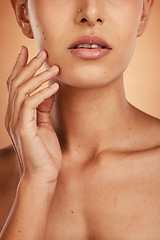 Image showing Hand, face and beauty with a model woman closeup in studio on a beige background for natural skincare. Wellness, luxury and cosmetics with a young female posing to promote a dermatology skin product