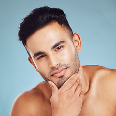 Image showing Skincare, portrait and man with idea for beauty, wellness and health against a blue studio background. Thinking, cosmetic and young model with a facial beard and dermatology for cleaning of skin