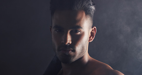 Image showing Fitness, portrait and man in dark studio with smoke for competition, game or gym challenge training with mock up for marketing, advertising or promotion. Face, sports and power of sexy model headshot