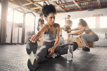 Image showing Stretching, fitness and training with black woman in gym with water bottle for exercise, sports and workout. Health, wellness and energy with girl and legs warm up for performance, muscle and strong