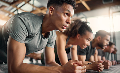 Image showing Gym, fitness and plank floor workout, challenge and power exercise by young people, focus and mindset. Training, planking and group on the ground for wellness, health and muscle, energy and strength