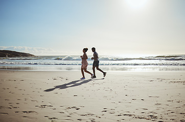 Image showing Exercise, couple and beach running at sunrise for health, training and wellness in nature against blue sky background. Fitness, family and woman with man on sand run along the sea, workout and cardio