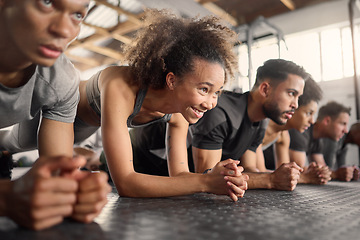 Image showing Fitness, woman and plank exercise in group training gym for wellness, healthy lifestyle and workout. Strong, young and happy black girl, athlete and floor push up with friends for sports challenge