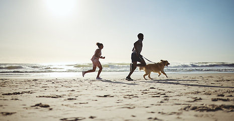 Image showing Fitness, couple and dog at beach for running, health and exercise in nature, sand and blue sky background. Ocean, workout and woman with man on cardio run with pet labrador, training and wellness