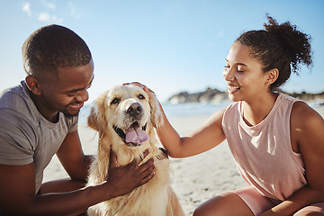 Image showing Relax, couple and dog at a beach, happy and smile while bonding, sitting and touching their puppy against blue sky background. Love, black family and pet labrador enjoy a morning outing at the ocean