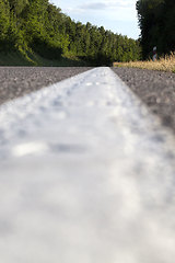 Image showing close-up of an asphalt road with white road markings