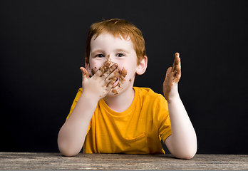 Image showing boy smeared in milk chocolate