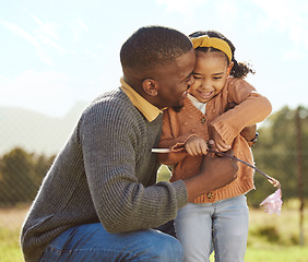 Image showing Black man hug girl kid in park, garden and grass field outdoors for love, care and quality time together on fathers day. Happy dad, excited child and black family picking spring flowers in sunshine