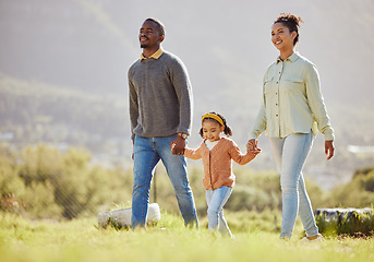 Image showing Happy family, walking and relax at a park with girl and parents, holding hands and enjoy their bond, freedom and trust. Love, black family and child with mom and dad on a walk in the countryside