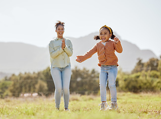 Image showing Mother, girl and child jumping, playing and clapping in game in nature park, garden environment or sustainability field. Smile, happy or cheering mom and kid in energy, freedom or fun summer activity