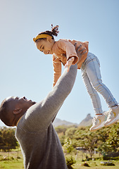 Image showing Father lifting kid in air at park, garden and nature outdoors for fun, bonding and quality time together as black family. Dad throwing girl child in in sky while playing with love, care and relax