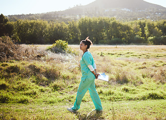 Image showing Animal care, working and vet in field walking with clipboard doing research, analytics and inspection. Healthcare, veterinary and black woman medical worker doing work, examination and job in nature