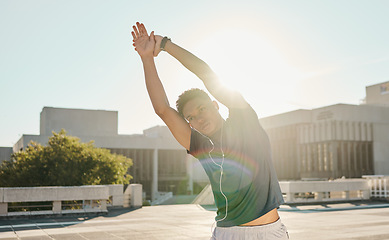 Image showing Fitness, stretching and music with sports man in a city for running, health and morning cardio, zen and mindset. Sports man, arm stretch and podcast by black man prepare body for workout at sunrise