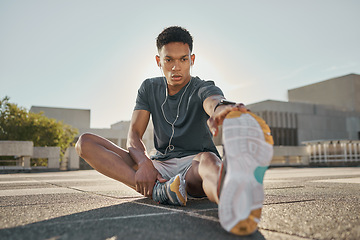 Image showing Fitness, earphones and man stretching hamstring in city for training, exercise or cardio workout or health warm up. Wellness, male and listening to music with healthy workout outdoor in summer