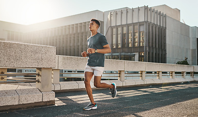 Image showing Fitness, health and city man running on street with motivation, healthy mindset and summer morning energy for training. Urban workout, cardio exercise and runner on bridge, focus on sports lifestyle.