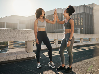Image showing Fitness, friends and high five in the city for workout, exercise or healthy training together in the outdoors. Happy women touching hands in partnership for sports wellness, exercising or run in town