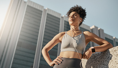 Image showing Fitness, music and city black woman thinking of training, running or workout goals, motivation and wellness with 5g technology. Focus runner with sports electronics listening to audio for exercise