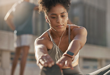 Image showing Music, headphones and black woman stretching for fitness warm up, cardio exercise and training for marathon race. Workout, health commitment and runner listening to radio or streaming audio podcast