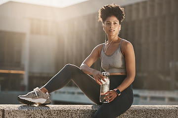 Image showing Fitness, earphones and black woman, water bottle break and training workout, exercise and motivation in urban city. Thinking young athlete, sports hydration and nutrition for body, wellness and goals