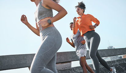Image showing Women, black man and running in city fitness, workout or exercise for cardio health, wellness or marathon training. Sports people, friends or runner athletes on New York street with energy or speed
