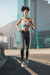 Image showing Running, fitness and city with a sports woman on a street for a cardio or endurance workout alone in the day. Health, training and exercise with a female athlete or runner on an asphalt road in town