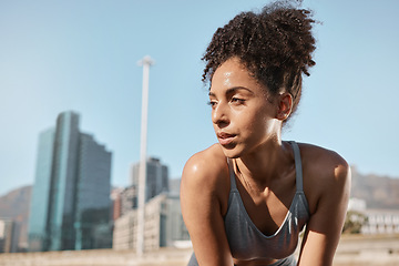 Image showing Fitness, runner and tired black woman in a city sweating from running exercise, cardio workout or training. Breathing, fatigue and sports athlete relaxing or resting on a break on a sunny summers day