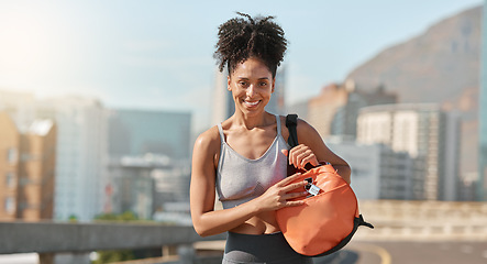 Image showing Black woman, gym bag and city for fitness, workout and strong exercise outdoors. Portrait of young african athlete holding luggage for training, sports and healthy lifestyle with urban background