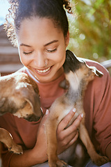 Image showing Happy, care and girl playing with dogs at animal adoption center with excited smile holding puppy. Happiness, black woman and loyalty of foster pets with caring lick for bond and trust.