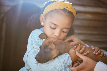 Image showing Dog, kiss and child outdoor with a love hug, care and animal friend care for new family puppy. Pet, girl and happiness together of a relax animal and kid hugging with parent help feeling calm in sun
