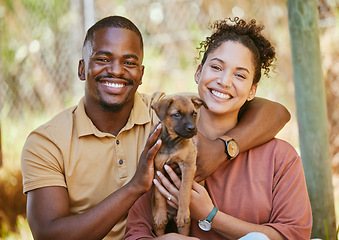 Image showing Love, portrait and black couple with dog at animal shelter for adoption at kennel. Support, care or happy interracial couple, man and woman bonding with foster puppy or pet and enjoying time together