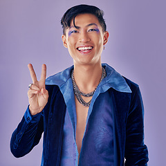 Image showing Fashion, peace sign and smile of punk man in studio with smile and vintage, retro or pop art clothes on color background for motivation. Gen z asian aesthetic lgbt or gay model with pride on purple