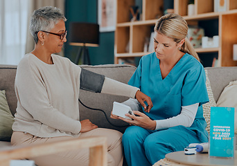 Image showing Test, consultation and doctor with a patient for blood pressure exam, healthcare and care in nursing home on the sofa. Medical, support and senior woman with a nursing caregiver with check on health