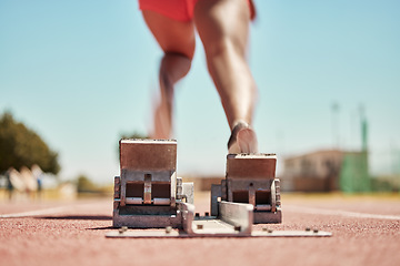 Image showing Stadium, back view and runner on start blocks for sprint, race or competition outdoors. Sports, woman or black female sprinter running with energy, speed or strength for fitness, training or marathon