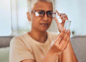 Image showing Glasses, medicine and pills senior woman reading information for healthcare, insurance and wellness at home. Elderly or old woman check label bottle or container for medical pharmaceutical medication