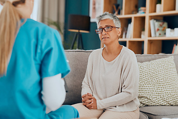 Image showing Nurse, senior woman and consultation on sofa in home for health check up or examination. Healthcare, consulting and female doctor with elderly patient in living room discussing treatment options.