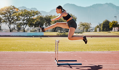 Image showing Jump hurdle, athlete and woman in competition, on track or running to win, for wellness and healthy. Fitness, female and girl training, exercise and workout for health, cardio and jumping for victory