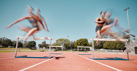 Image showing Fitness, jump or running women in a hurdles sports competition or athletes racing event with speed. Training, exercise and fast girl sprinters jumping in a track and field race at a runners stadium