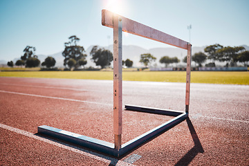 Image showing Empty stadium, field and running hurdle or barrier at outdoors race track. Sports, athletics or jumping obstacle, metal equipment for runners or athletes for competition, exercise or training outside