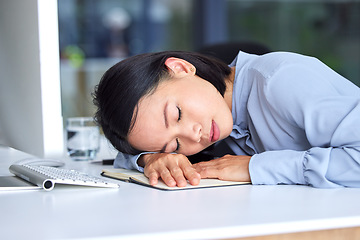 Image showing Burnout, tired and business woman sleeping on the desk in her modern office while planning a strategy. Fatigue, overworked and professional employee taking nap at workplace while working on a project