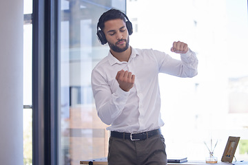 Image showing Businessman, headphones and dance to audio motivation in office for freedom or happiness. Man, music and listening online podcast in corporate workplace or disco dancing success celebration at desk