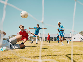 Image showing Soccer, children and sports with a boy team playing a game on a grass pitch or field for competition or fun. Football, fitness and training with kids outdoor to play a competitive sport match