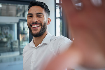 Image showing Selfie, happy and success with a business man taking a picture while standing alone in the office at work. Portrait, confidence and smile with a male employee posing for a photograph while working