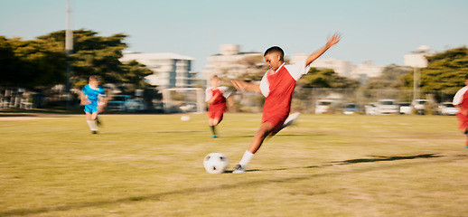 Image showing Sports game, soccer and child shooting, kick or strike ball to score winning goal in contest, competition or match. Fitness workout, training exercise or youth soccer player playing on football field