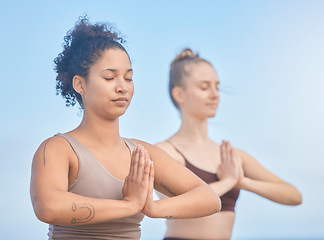 Image showing Yoga, meditation and women with exercise in nature to relax, breathe and care for their mind. Fitness, motivation and friends training for wellness and hope with spiritual workout against a blue sky