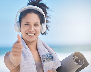 Image showing Thumbs up, woman and headphone, fitness and exercise, yoga and motivation in Miami. Portrait of happy fitness female celebration, success and excited goal for achievement, yes sign and like emoji